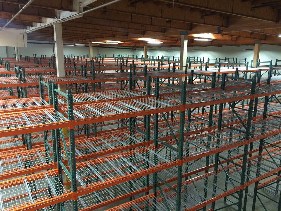 Rows of industrial pallet racks loaded with pallets in a warehouse